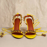 Bright yellow strappy heeled sandals with bronze embellished details and ankle tie closures — Subashini Heels | Endless UAE