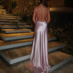 Elegant backless satin maxi dress in champagne pink with halter neckline and flowing silhouette — By Keara | Endless UAE