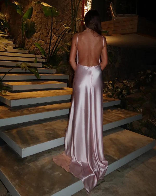 Elegant backless satin maxi dress in champagne pink with halter neckline and flowing silhouette — By Keara | Endless UAE