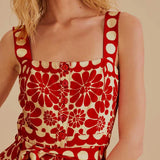 Woman wearing red and cream sleeveless romper with geometric pattern — Farm Rio | Endless UAE