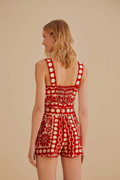 Woman wearing red and cream sleeveless romper with geometric pattern — Farm Rio | Endless UAE