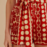 Woman wearing red and cream sleeveless romper with geometric pattern — Farm Rio | Endless UAE