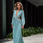 Woman wearing a flowing light blue wrap dress with long sleeves and cutout waist detail — Anne Louise Boutique | Endless UAE