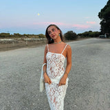 White lace camisole maxi dress styled with accessories in a desert setting — Scorpio Rizing | Endless UAE