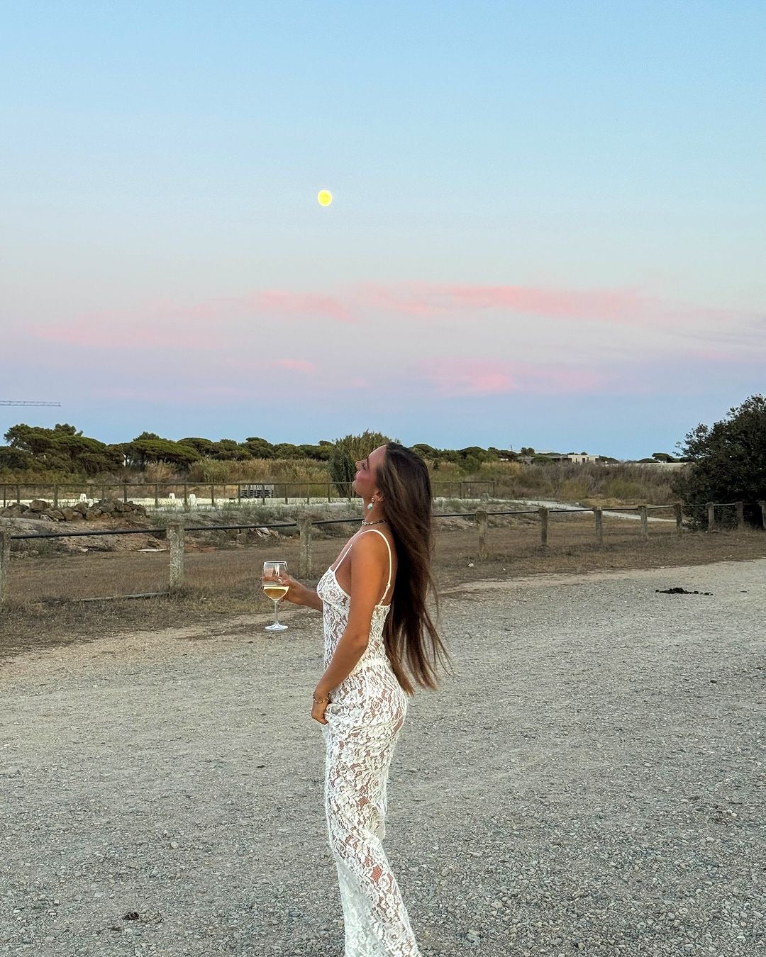 White lace camisole maxi dress styled with accessories in a desert setting — Scorpio Rizing | Endless UAE