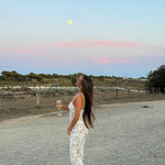 White lace camisole maxi dress styled with accessories in a desert setting — Scorpio Rizing | Endless UAE