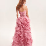 Rear view of model wearing pink strapless gown with dramatic rose-shaped ruffled skirt and lace-up corset back — Milla | Endless UAE