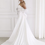 Elegant strapless white wedding gown with dramatic bow detail and flowing train — You&I Bridal | Endless UAE