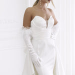 Elegant strapless wedding gown with feathered gloves and sculptural bodice in luxurious white satin — You&I Bridal | Endless UAE