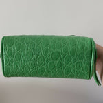 Green crocodile-embossed mini tote bag with gold hardware held by hand — By Far | Endless UAE
