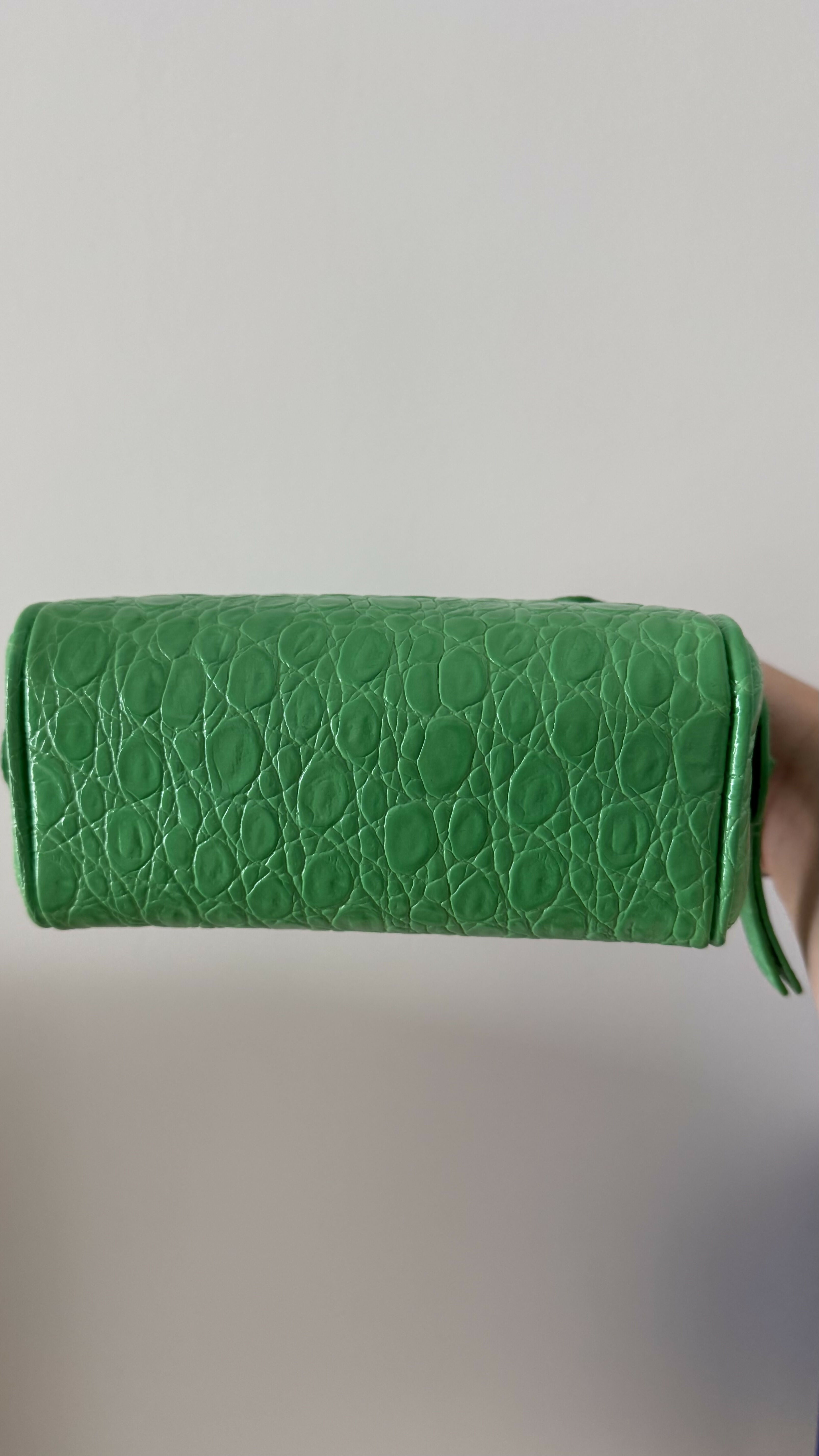 Green crocodile-embossed mini tote bag with gold hardware held by hand — By Far | Endless UAE