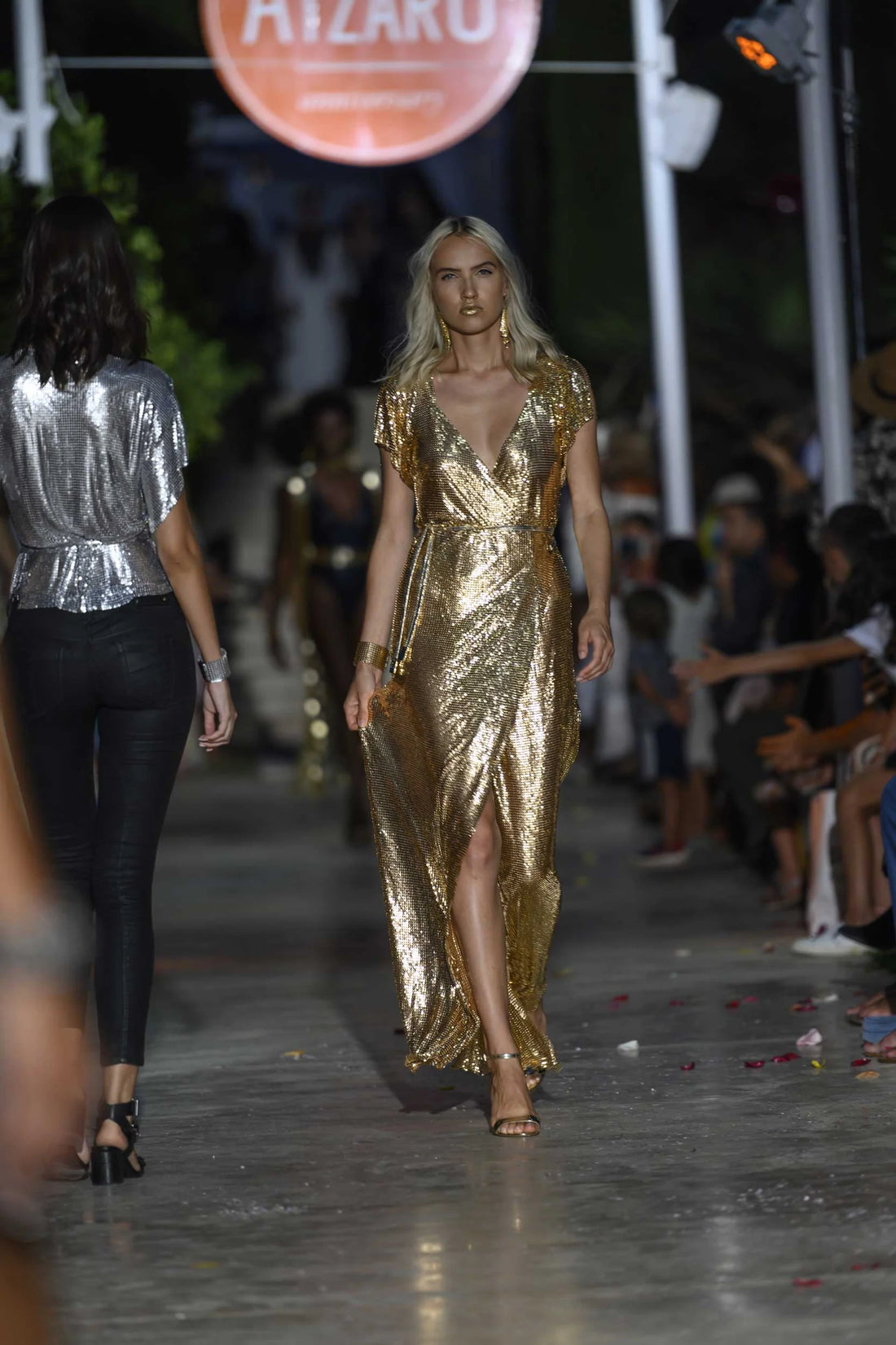 Gold sequin wrap dress on runway model at fashion show — Isabel Moore | Endless UAE