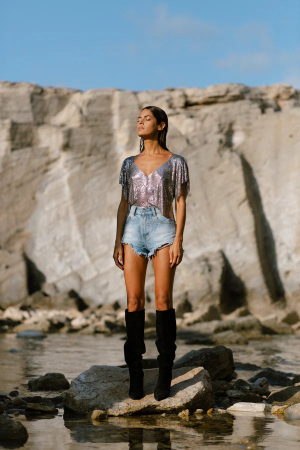 Gunmetal Ava Top worn by woman at beach with rocky cliff backdrop — Isabel Moore | Endless UAE