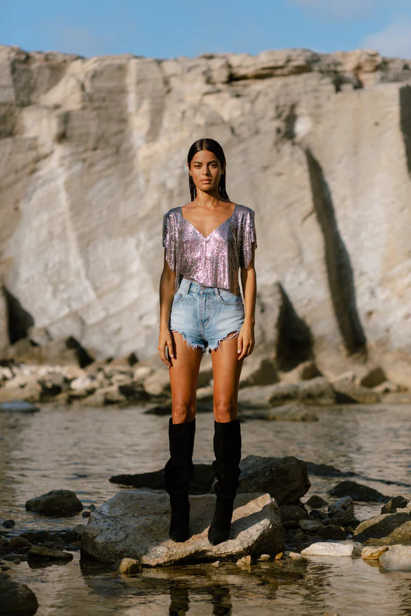 Gunmetal Ava Top worn by woman at beach with rocky cliff backdrop — Isabel Moore | Endless UAE