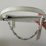 White quilted mini shoulder bag with silver hardware held up against neutral background — By Far | Endless UAE