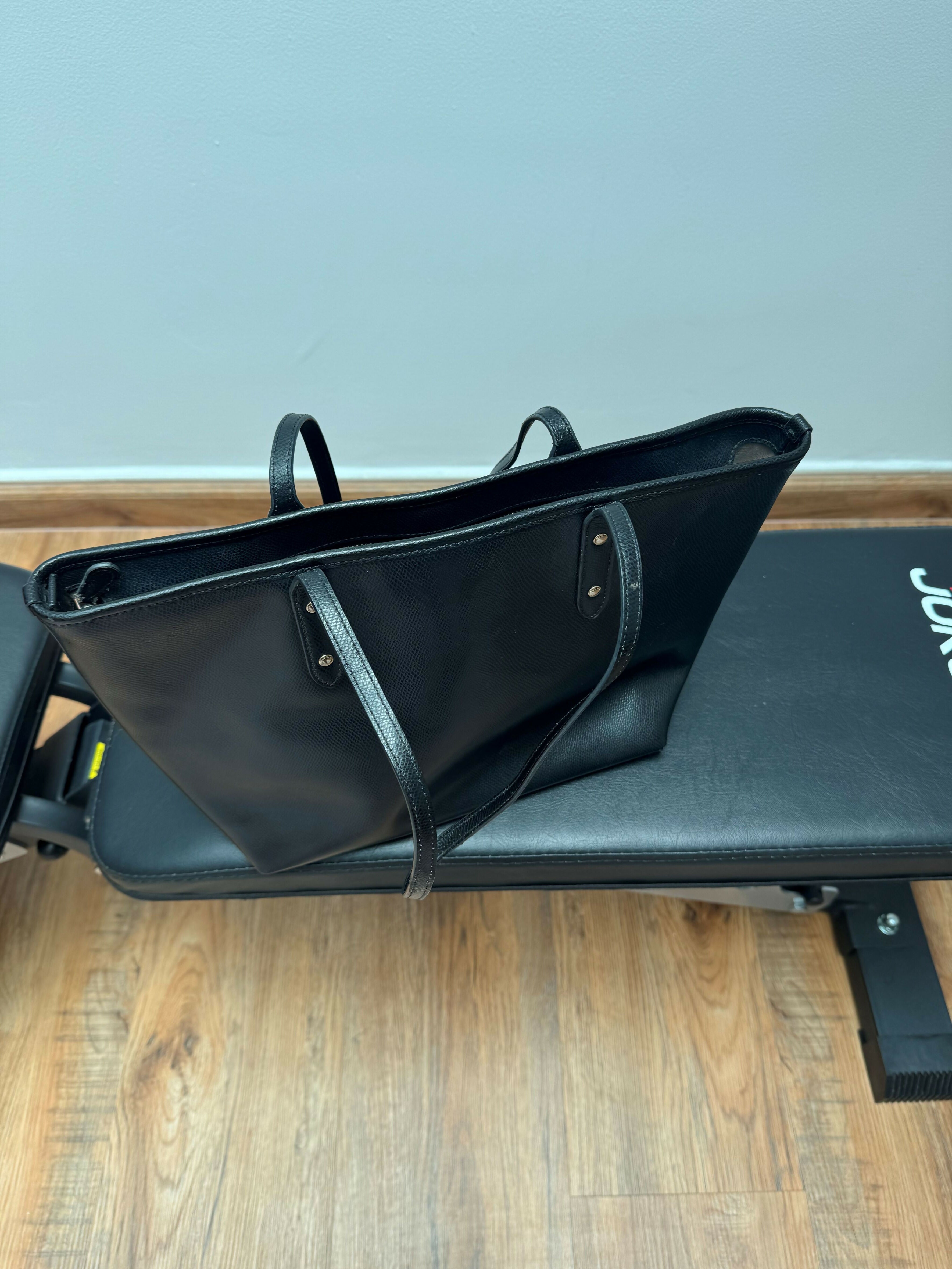 Black leather tote bag with dual handles and Coach branding — Coach | Endless UAE