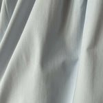 Woman wearing light blue sleeveless midi dress with corset top and full skirt — Endless | Endless UAE