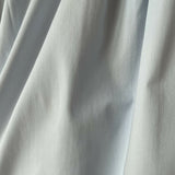 Woman wearing light blue sleeveless midi dress with corset top and full skirt — Endless | Endless UAE
