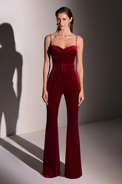 Elegant red velvet jumpsuit with sweetheart neckline, embellished straps, and belted waist — Nadine Merabi | Endless UAE