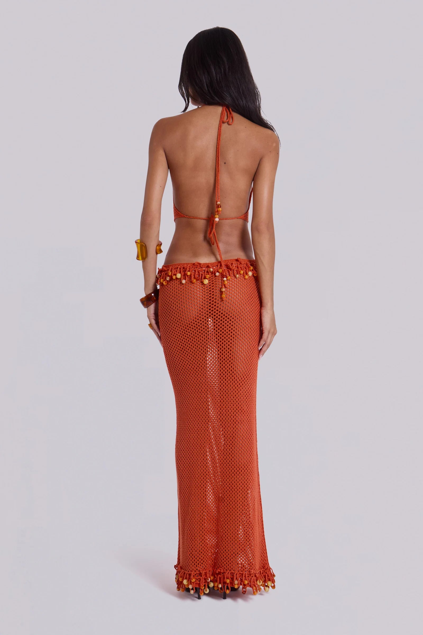 Woman wearing orange beaded crochet halter maxi dress with open back — Jaded London | Endless UAE