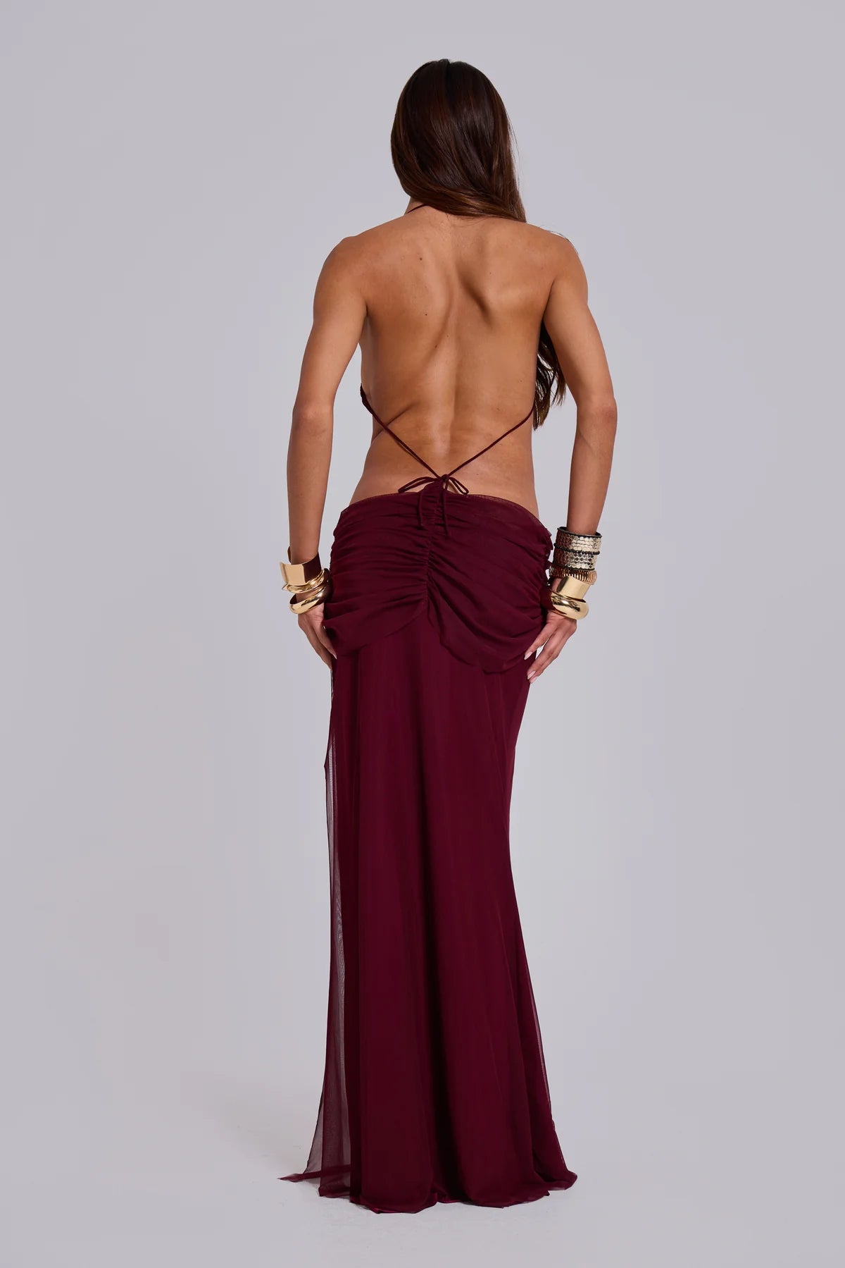 Burgundy halter neck backless maxi dress with draped detailing and gold cuff bracelets — Jaded London | Endless UAE
