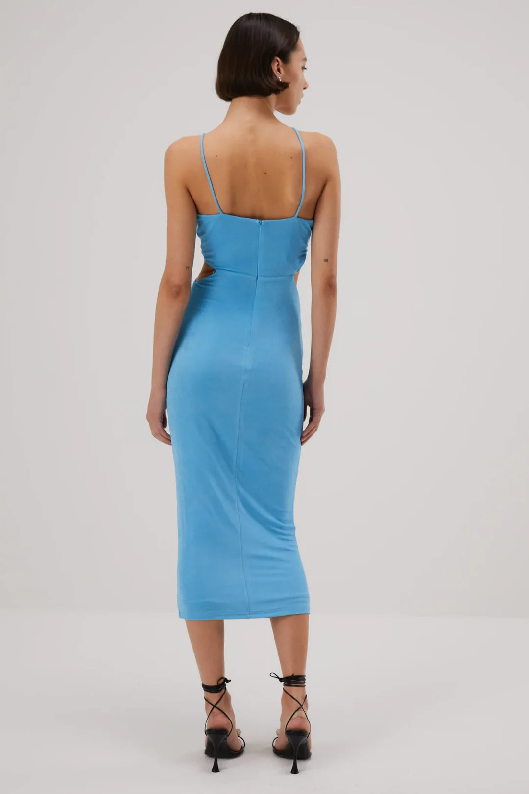 Blue fitted midi dress with thin straps and back zipper closure, shown from behind — Misha | Endless UAE