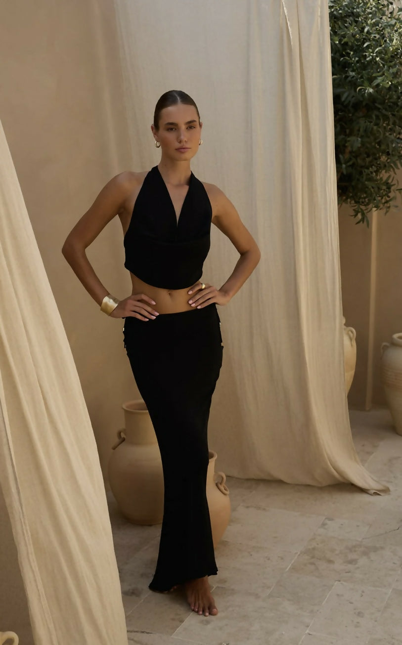 Black maxi skirt with ruched side detailing and flared silhouette worn with matching halter top — Beach City | Endless UAE