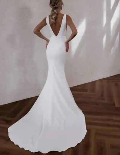Elegant fitted mermaid wedding dress with deep V-back and train in luxe crepe fabric — Made with Love | Endless UAE