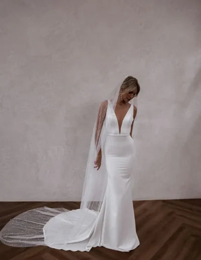 Sleek fitted wedding dress with plunging neckline and sparkle cathedral veil — Made with Love | Endless UAE