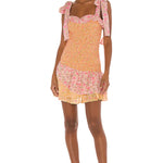 Floral smocked mini dress with tie shoulder straps and ruffled hem in pink and yellow — LoveShackFancy | Endless UAE
