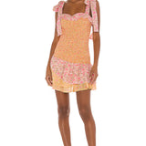 Floral smocked mini dress with tie shoulder straps and ruffled hem in pink and yellow — LoveShackFancy | Endless UAE