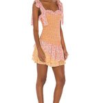 Floral smocked mini dress with tie shoulder straps and ruffled hem in pink and yellow — LoveShackFancy | Endless UAE