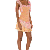Floral smocked mini dress with tie shoulder straps and ruffled hem in pink and yellow — LoveShackFancy | Endless UAE