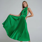 Woman wearing emerald green pleated halter maxi dress with cutout details and tan sandals — L'Idee | Endless UAE