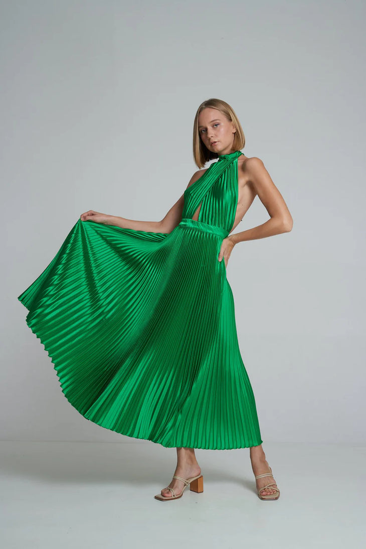 Woman wearing emerald green pleated halter maxi dress with cutout details and tan sandals — L'Idee | Endless UAE