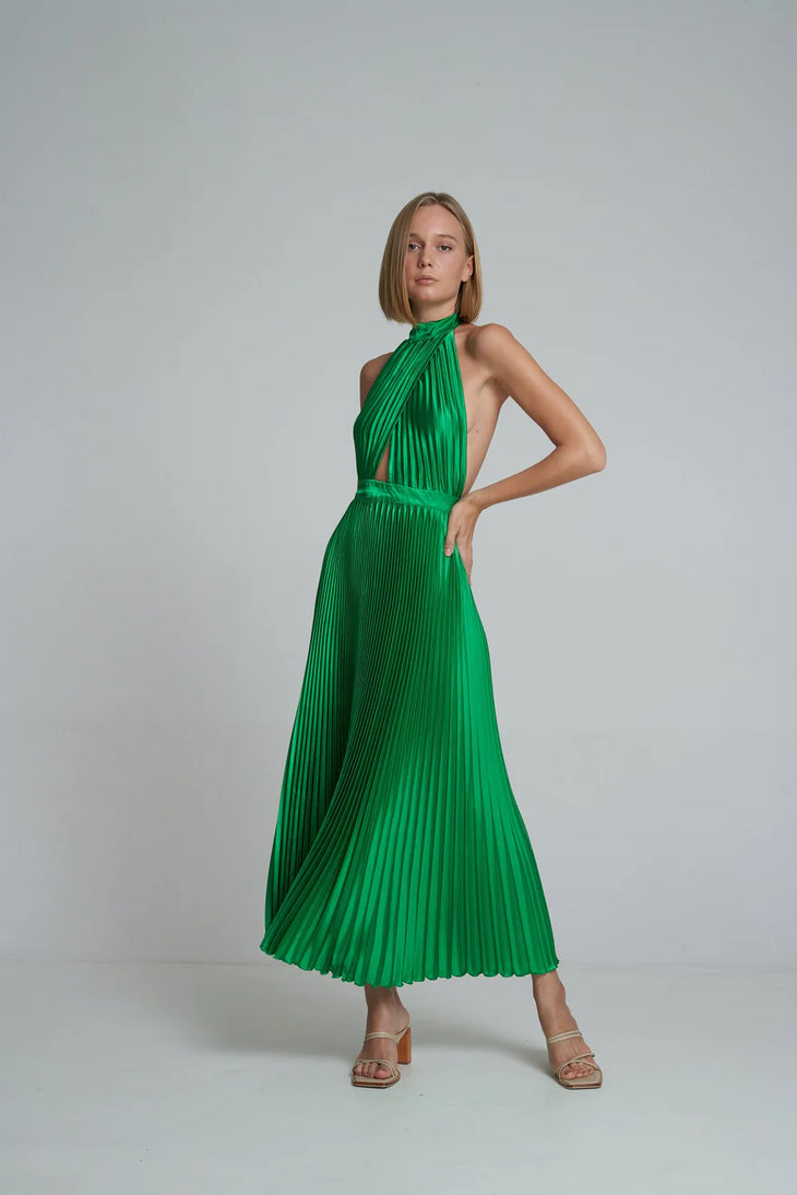 Woman wearing emerald green pleated halter maxi dress with cutout details and tan sandals — L'Idee | Endless UAE