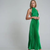 Woman wearing emerald green pleated halter maxi dress with cutout details and tan sandals — L'Idee | Endless UAE