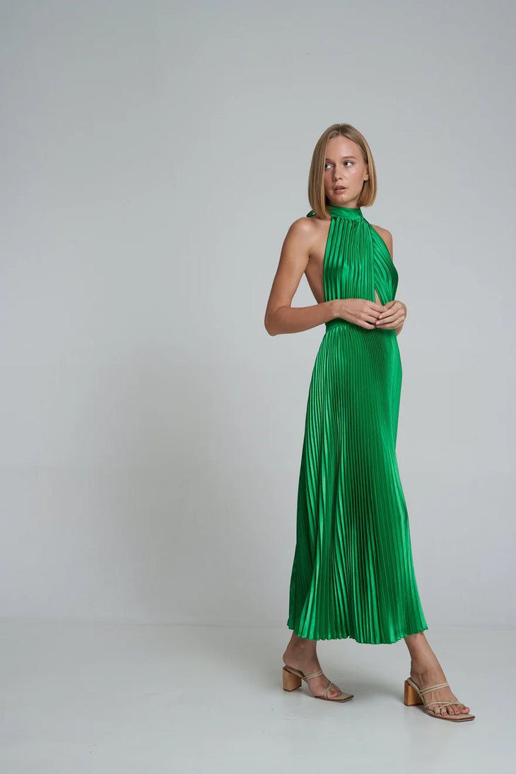 Woman wearing emerald green pleated halter maxi dress with cutout details and tan sandals — L'Idee | Endless UAE