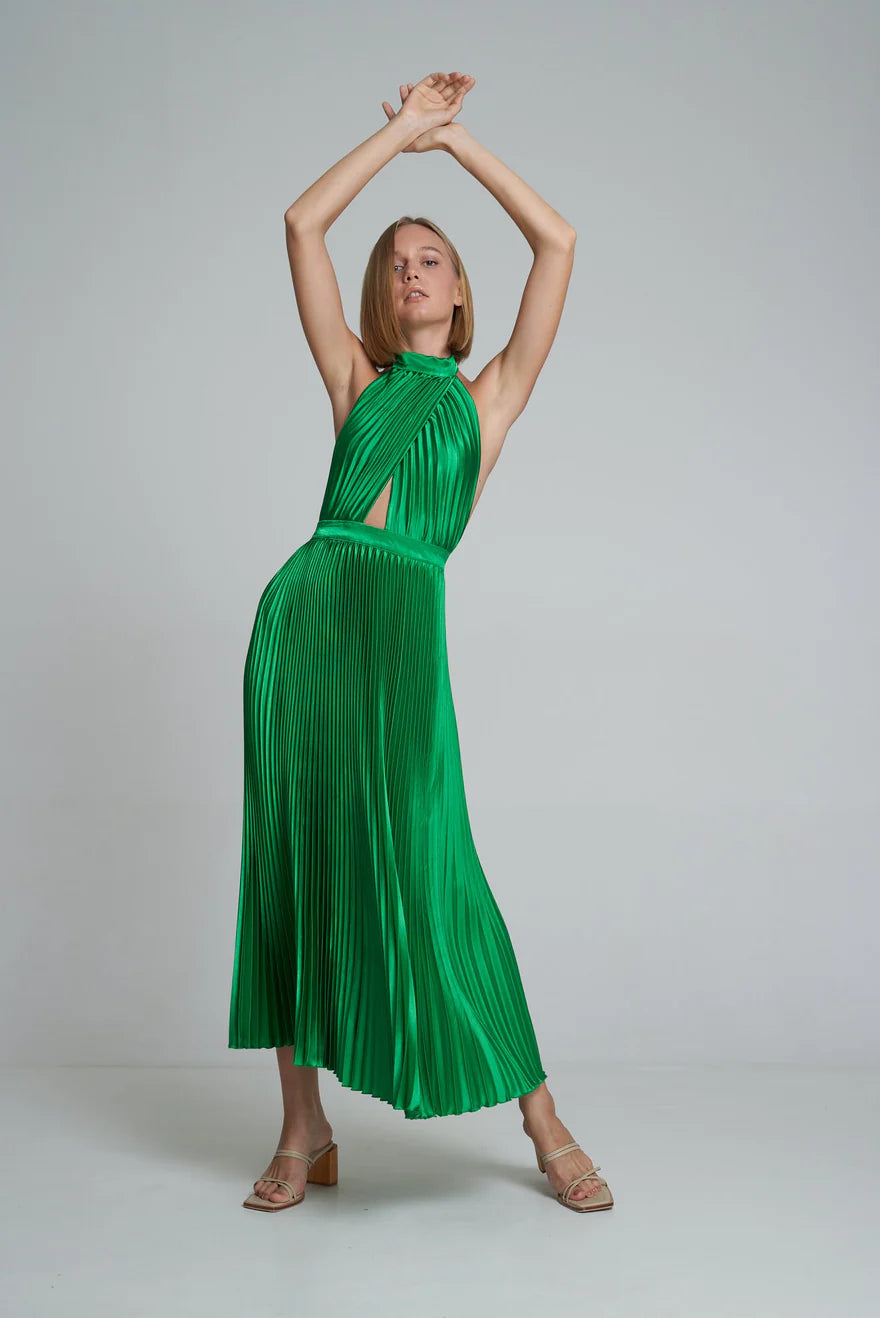 Woman wearing emerald green pleated halter maxi dress with cutout details and tan sandals — L'Idee | Endless UAE