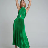 Woman wearing emerald green pleated halter maxi dress with cutout details and tan sandals — L'Idee | Endless UAE