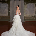 Elegant tiered tulle wedding gown with crystal-embellished bodice and dramatic train in vintage ballroom — You&I Bridal | Endless UAE