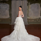 Elegant tiered tulle wedding gown with crystal-embellished bodice and dramatic train in vintage ballroom — You&I Bridal | Endless UAE