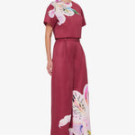Woman wearing burgundy crop top and wide-leg floral pants with colorful lily print — Leo Lin | Endless UAE