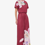 Woman wearing burgundy crop top and wide-leg floral pants with colorful lily print — Leo Lin | Endless UAE