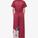 Woman wearing burgundy crop top and wide-leg floral pants with colorful lily print — Leo Lin | Endless UAE