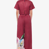 Woman wearing burgundy crop top and wide-leg floral pants with colorful lily print — Leo Lin | Endless UAE
