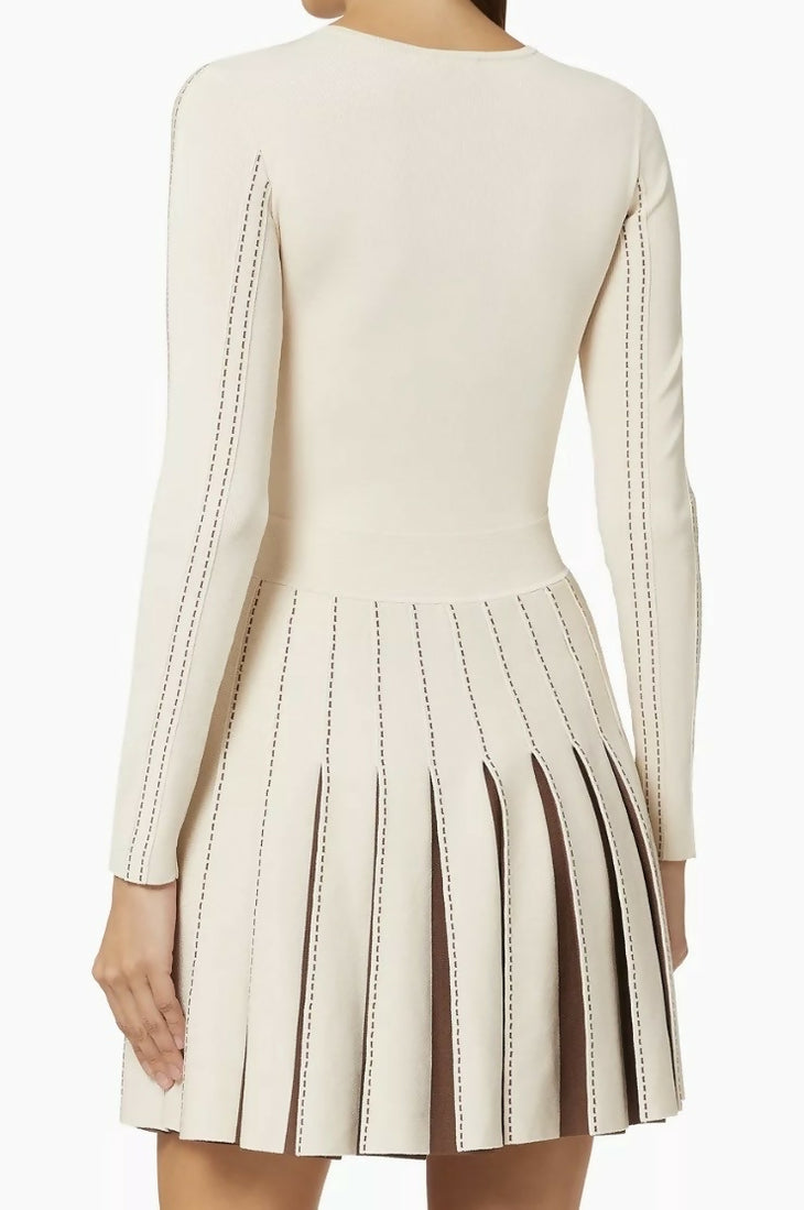 Cream knit dress with contrasting dark stitching detail and pleated skirt, back view — Elisabetta Franchi | Endless UAE