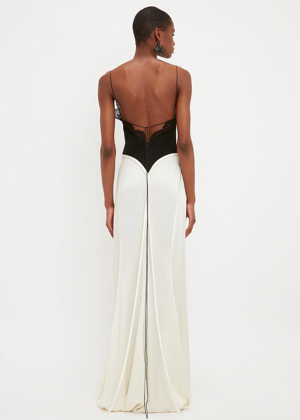 Woman wearing black lace insert bodysuit with cream floor-length skirt — Victoria Beckham | Endless UAE