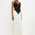 Woman wearing black lace insert bodysuit with cream floor-length skirt — Victoria Beckham | Endless UAE