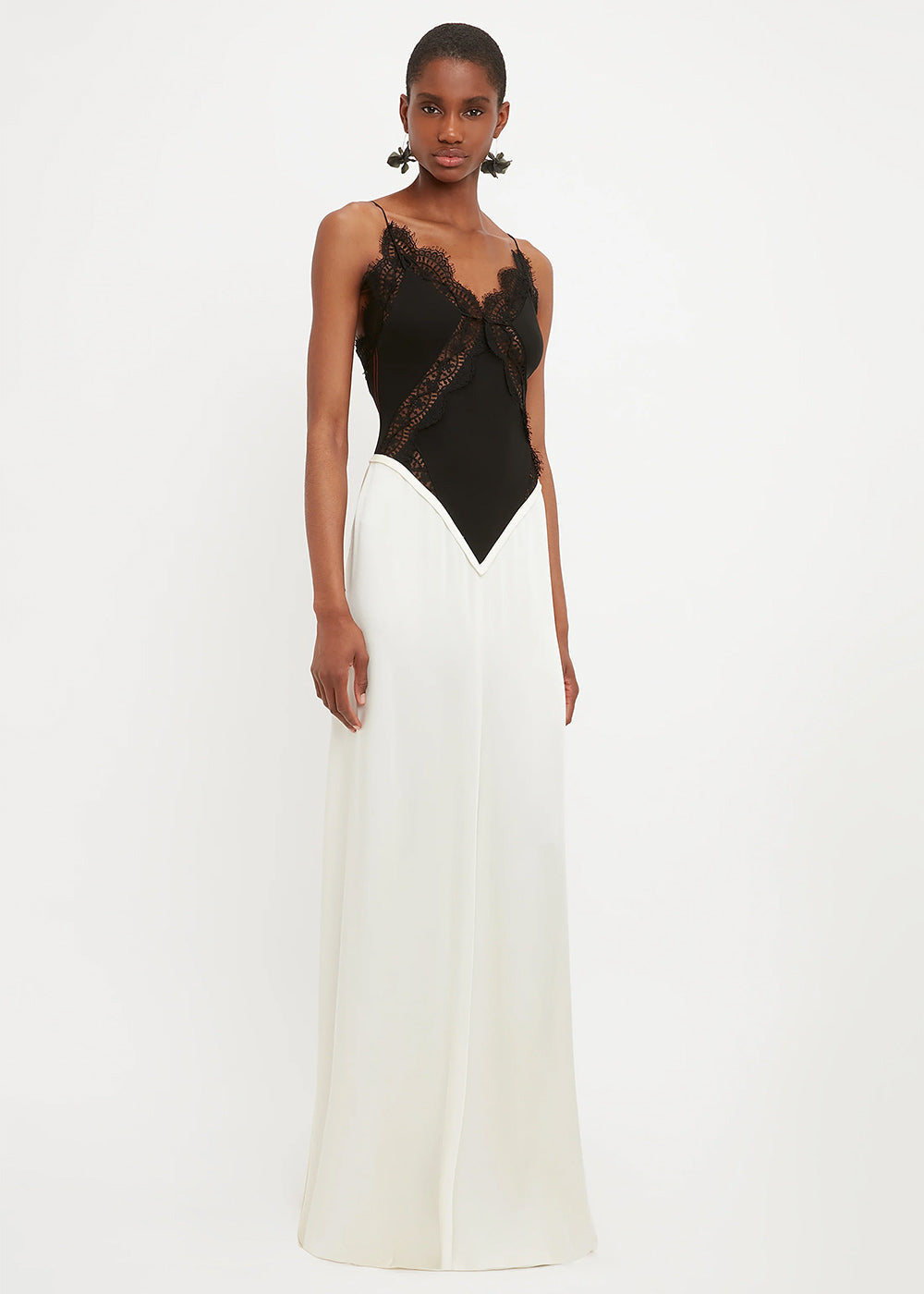 Woman wearing black lace insert bodysuit with cream floor-length skirt — Victoria Beckham | Endless UAE